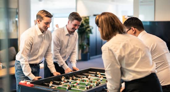 team playing foosball